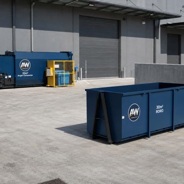 Two blue industrial containers outside a warehouse with closed shutters.