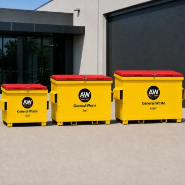 Three yellow general waste bins with red lids of different sizes outside a building.