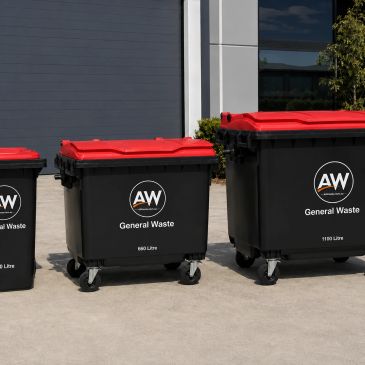 Three black general waste bins with red lids outside a building.