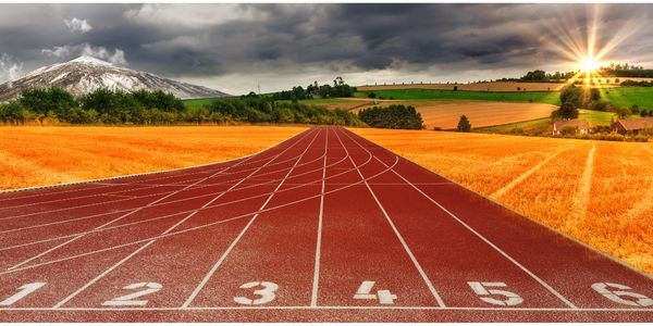 track athletics mountains and sunset