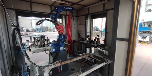 Industrial robotic arm inside a factory workstation.