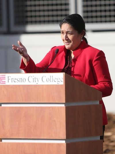Woman speaking at Fresno City College podium.