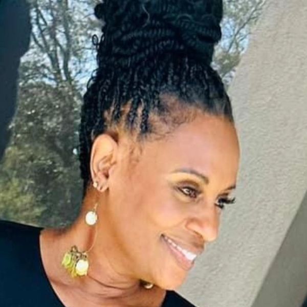 Woman with braided hair smiling.