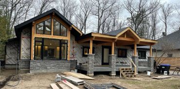 New house under construction in a wooded area.
