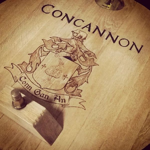 Wooden barrel lid engraved with the name Concannon and a family crest.