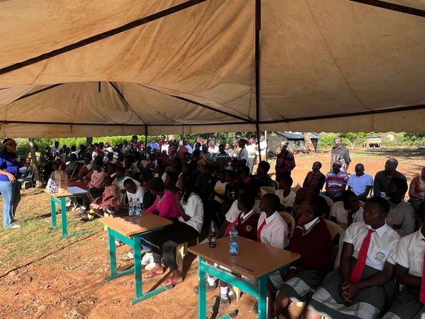 Purposeful travel event with a community and school to give womens health products