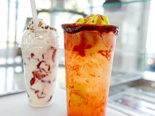 Two refreshing drinks, one iced with fruit and one creamy dessert drink.