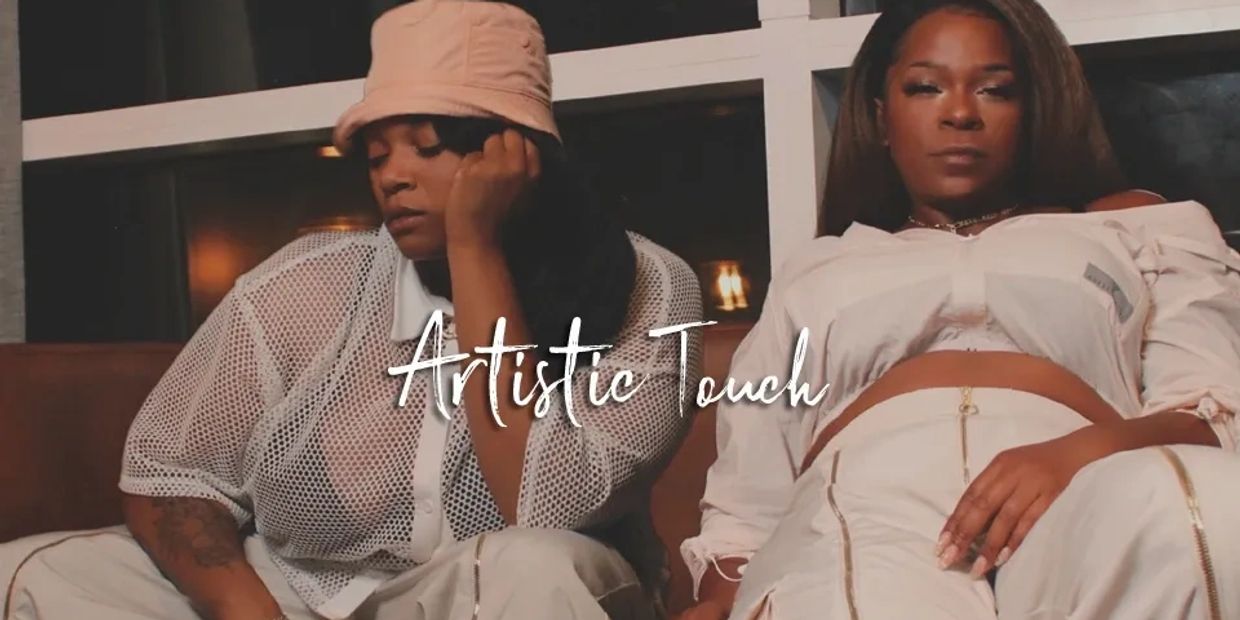 Two women in stylish outfits pose with 'Artistic Touch' text overlay.