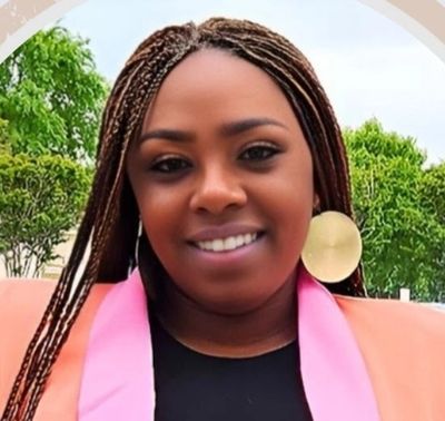 photo of Tabitha Tanner, a smiling woman with long braided dark hair.