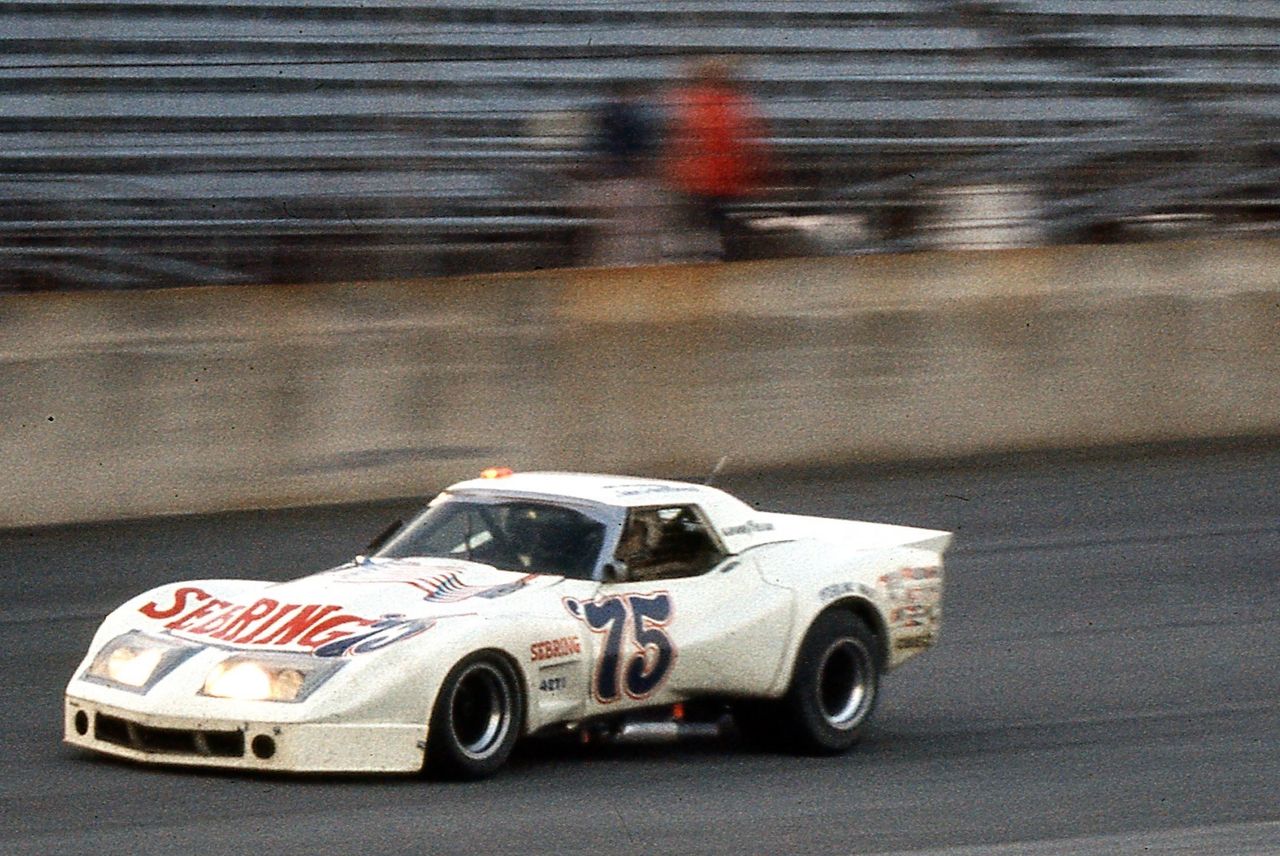 By the 1975 IMSA season, John Greenwood had firmly established himself as the torchbearer for Corvette performance at a time when the street car was being forced to evolve more quietly. While Chevrolet focused on compliance and survivability in the showroom, Greenwood was carrying the Corvette flag on track—showing up with wide, aggressive, unmistakably purposeful race cars that looked nothing like compromise. His IMSA Corvette wasn’t about nostalgia or rebellion; it was about proving, in real competition, that the Corvette platform still belonged in the fight. This car and this season set the tone for what Greenwood would represent throughout the mid-1970s: a relentless, privateer-driven commitment to keeping Corvette loud, visible, and competitive when it mattered most.