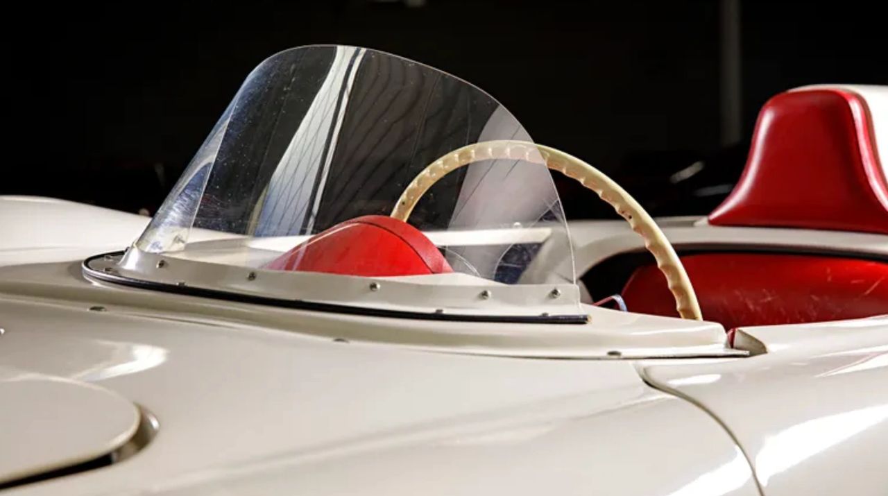 The low, wraparound windshield fitted to the EX-87 was a deliberate aerodynamic tool, not a styling flourish. By reducing frontal area and smoothing airflow over the cockpit, it helped stabilize the car at sustained high speeds while minimizing turbulence around the driver—critical factors during record-attempt testing. Just as important, the windshield offered a controlled compromise between outright drag reduction and driver protection, allowing Zora Arkus-Duntov to push the car harder and longer than an open cockpit would permit. In the EX-87’s mission, visibility, stability, and survivability were inseparable from performance. (Image source: MotorTrend.com)