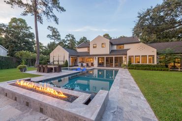 A view of a romantic pool outside a house