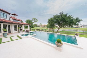 A view of a pool outside a house