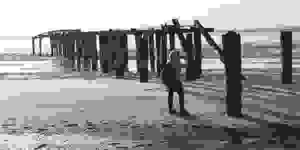 Walker relaxing and capturing imagery at sunset, Fraser Island Great Walk. 