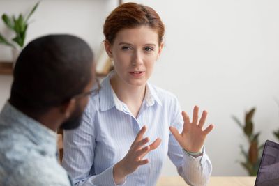 Female coach speaking with a male client