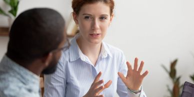 A coach speaking with her client