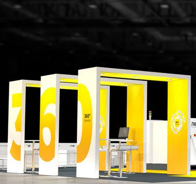Modern exhibition booth with yellow and white 360-degree service displays.