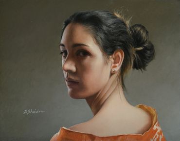 Portrait of a woman looking over her shoulder.