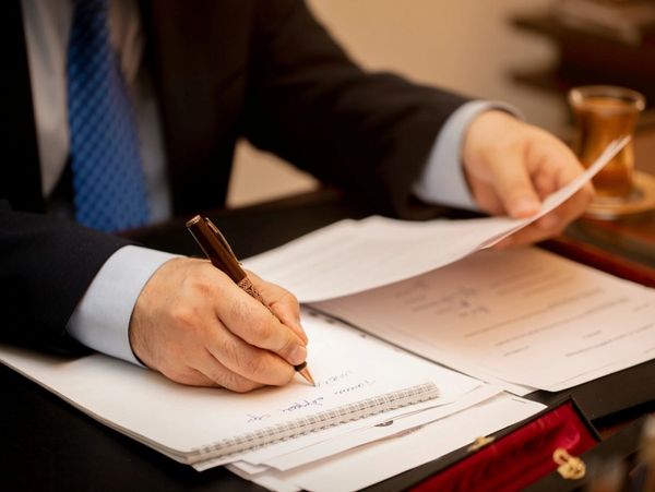 Los Angeles Alternative Dispute Lawyer sitting at his desk writing an Alternative Dispute resolution