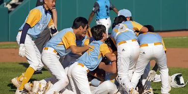 Little League World Series Williamsport PN. Kids piling on the mound celebrating win 