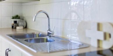 Modern kitchen sink with dual basins and a sleek faucet.