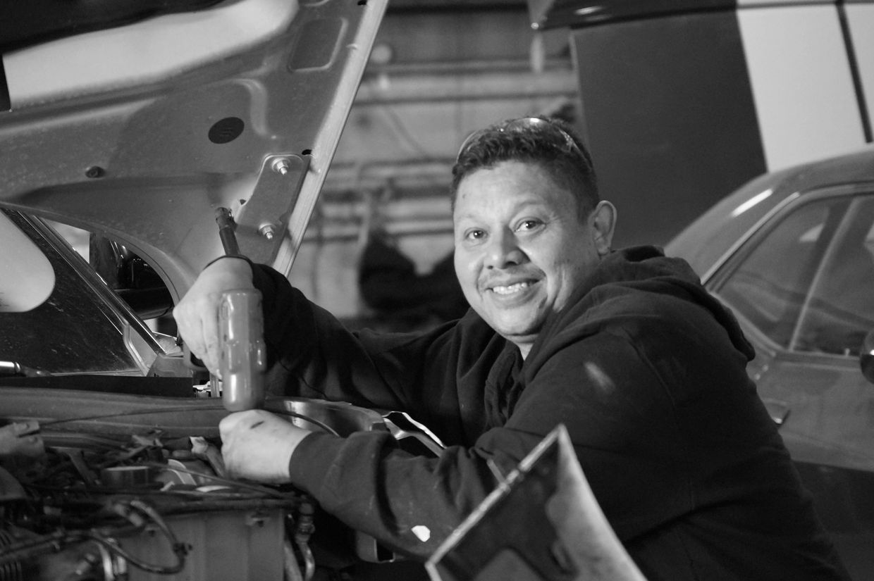 One of our expert auto body technicians repairs a vehicle at Denver’s best collision center near me.