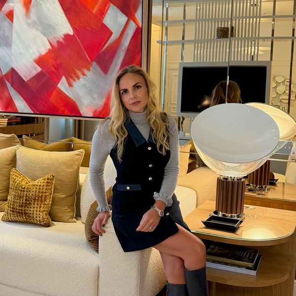 Woman sitting on a couch in a modern living room.