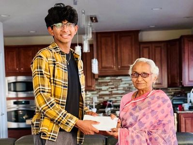 Heartfelt Humans founder Yash Sreepathi presents check to executive at the Anurag Foundation.