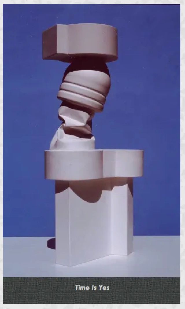 Abstract modern sculpture titled 'Time Is Yes' against a blue background.