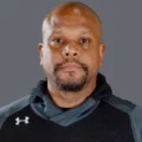 Portrait of a man in a black sports jacket.