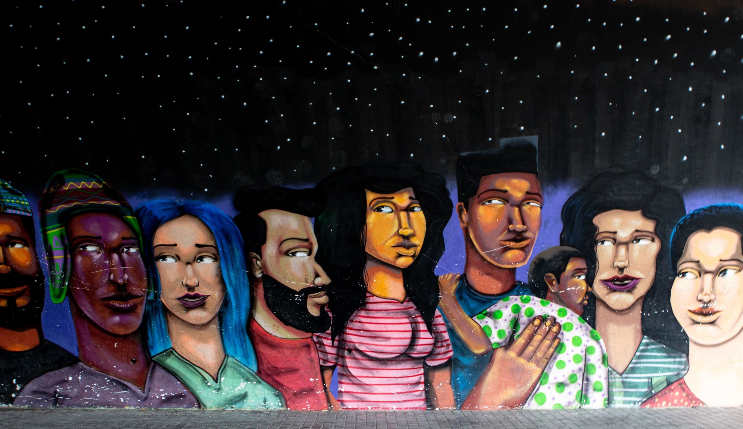 Drawing mural in Lima, Peru of diverse people.