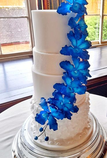 4 Tier wedding cake with ruffles and the 1/2 tier covered in edible sparkle, decorated with hand cra