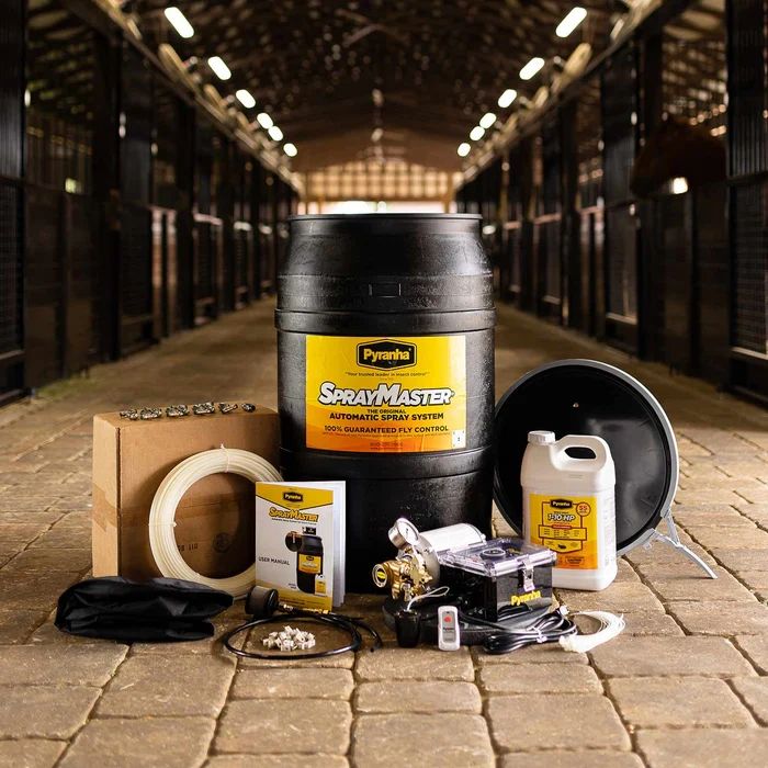 SprayMaster automatic spray system with accessories in a stable.