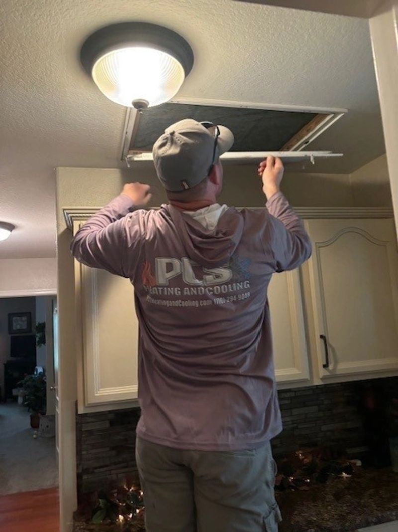 Replacing a ceiling air filter in a Phoenix home.