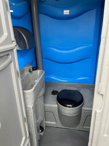 An inside look at our cold wash portable toilet, sink, and hand towels can be seen