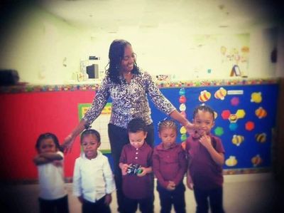 Teacher with young children in a classroom.