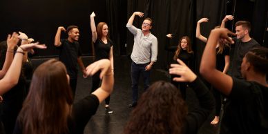 Group of people practicing dance moves.