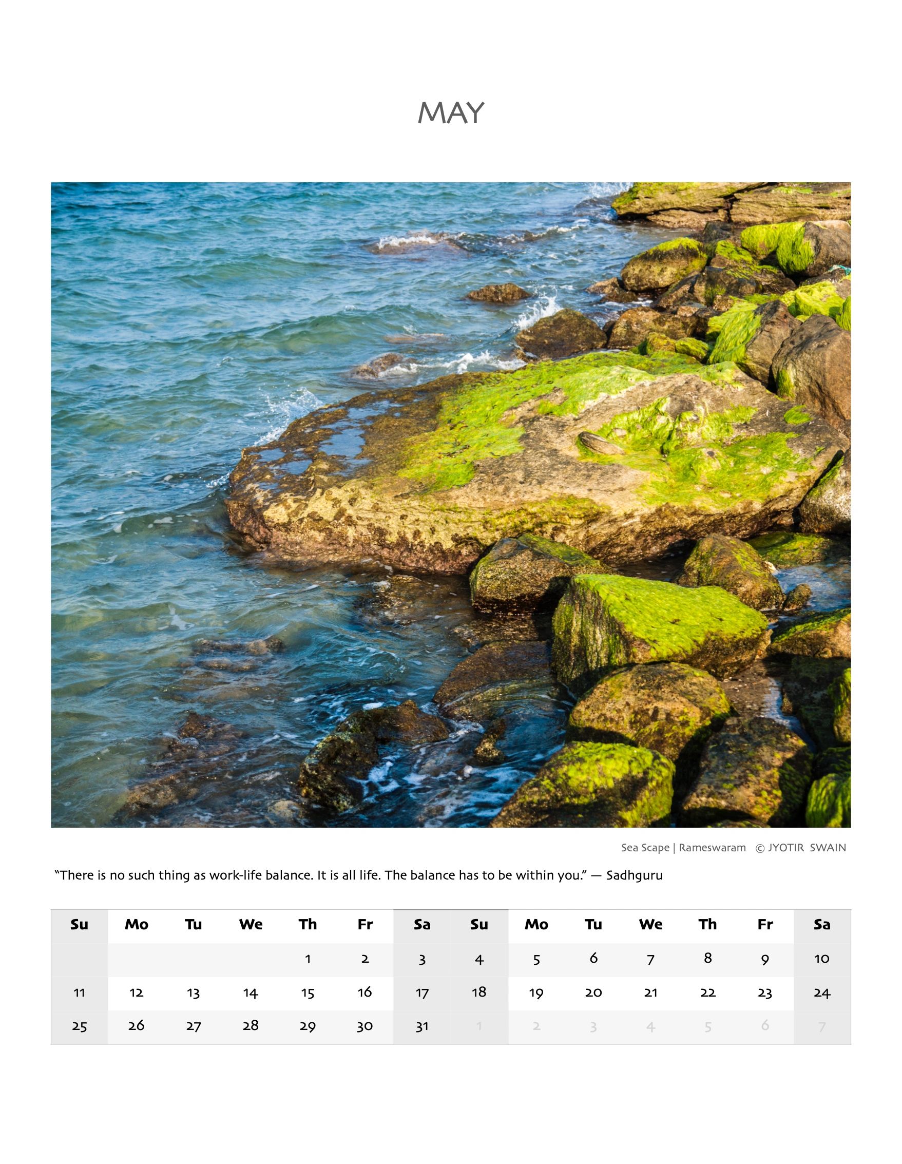 Moss-covered rocks by the blue sea at Rameswaram.