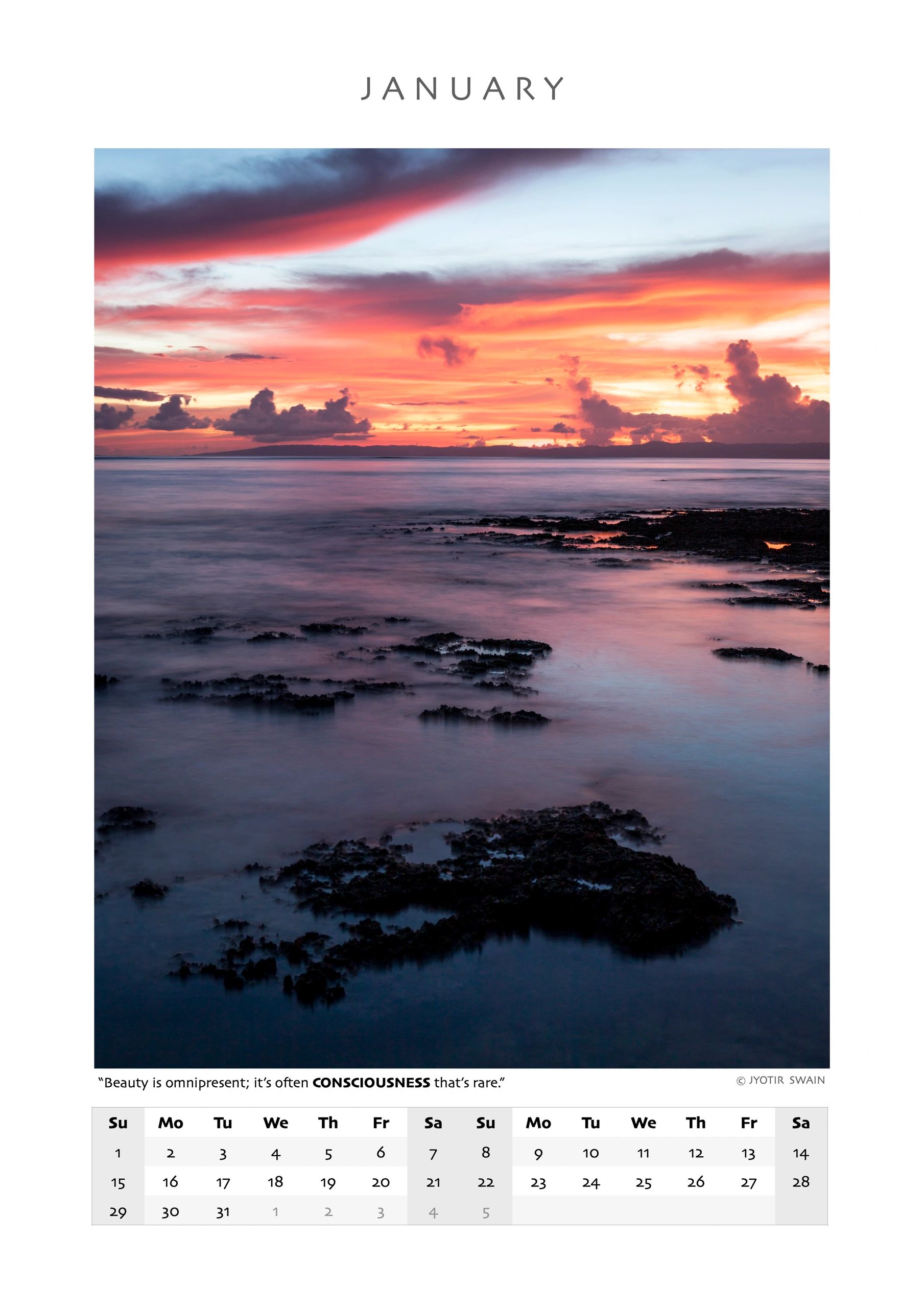 A serene coastal sunset with vibrant orange and purple hues over calm waters and rocky formations.