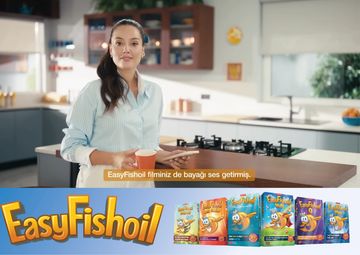 A woman in a kitchen promoting EasyFishoil with product packaging shown.