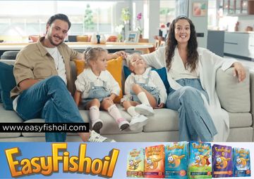 Happy family sitting on a couch with EasyFishoil products displayed below.