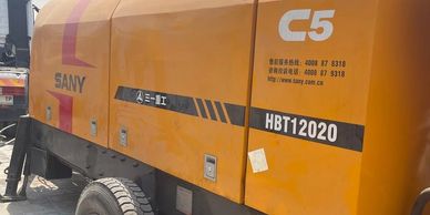 Yellow SANY construction machine with model HBT12020 and C5 markings.