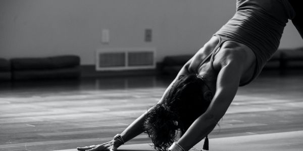 Person in a downward facing dog yoga posture.