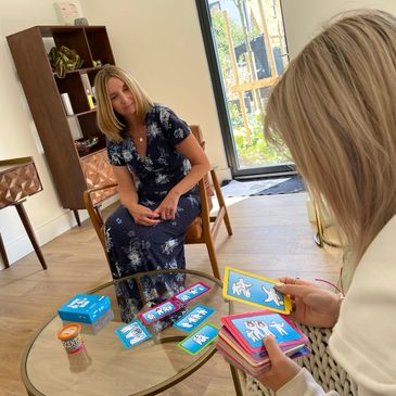 Children’s counsellor using mood cards to explore feelings with a teen client