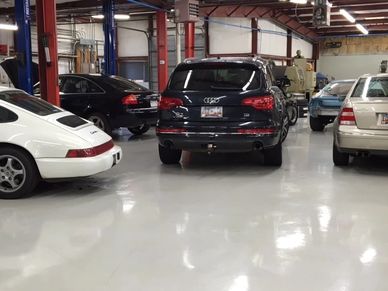 Luxury cars parked in a garage.