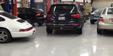 Luxury cars parked in a garage.