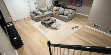 Cozy living room with sectional sofa and light wood flooring.