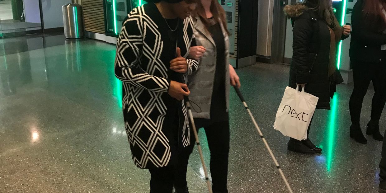Ramona teaching a client how to guide people with sight loss.