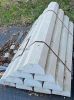 Stack of concrete fence posts tied together outdoors.