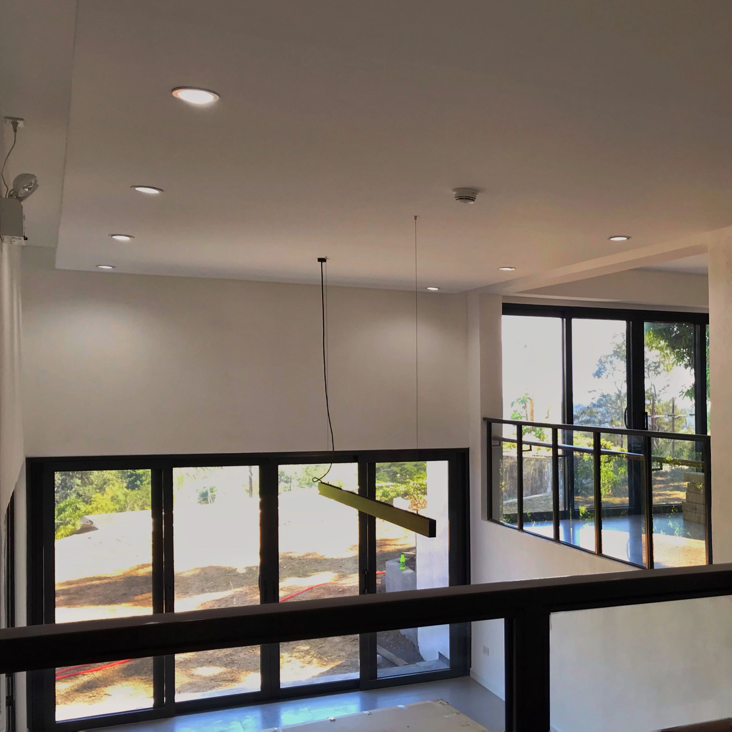 Modern interior with large glass doors and sleek lighting.